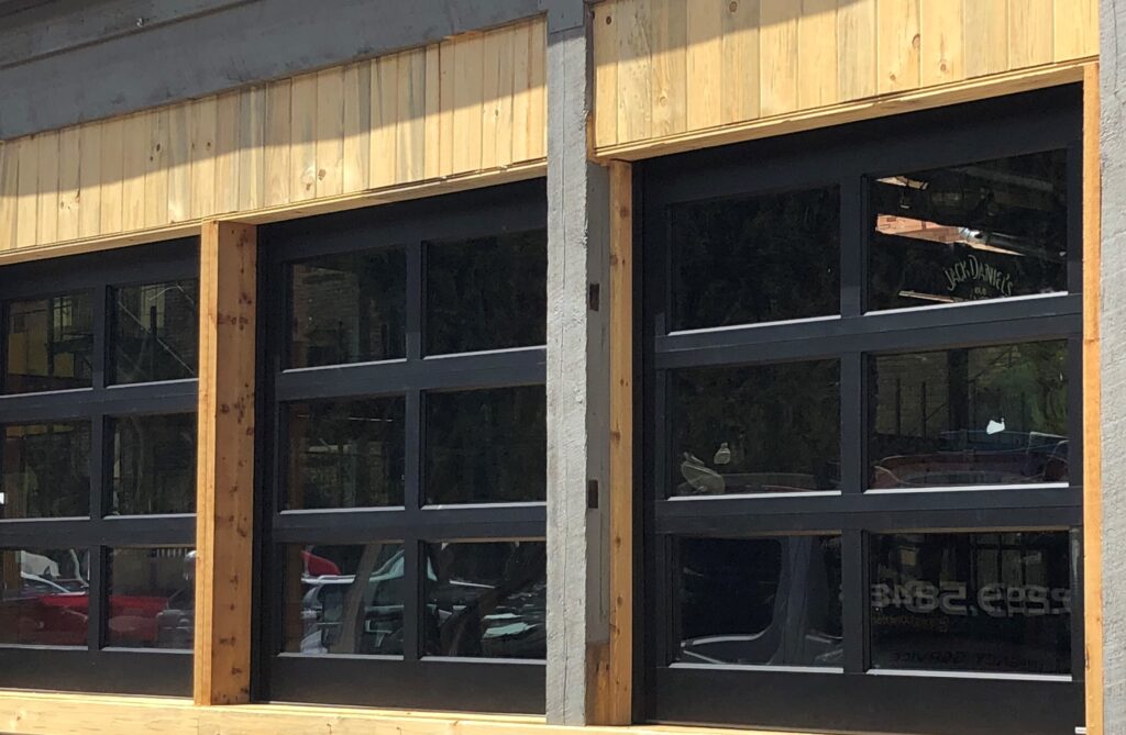 Wooden garage door with window pannels